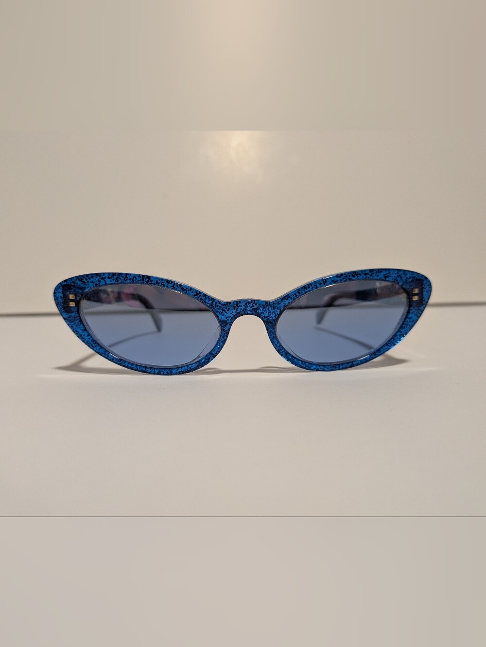 Miu Miu SMU 09U sunglasses, featuring a blue and silver glitter Cat eye